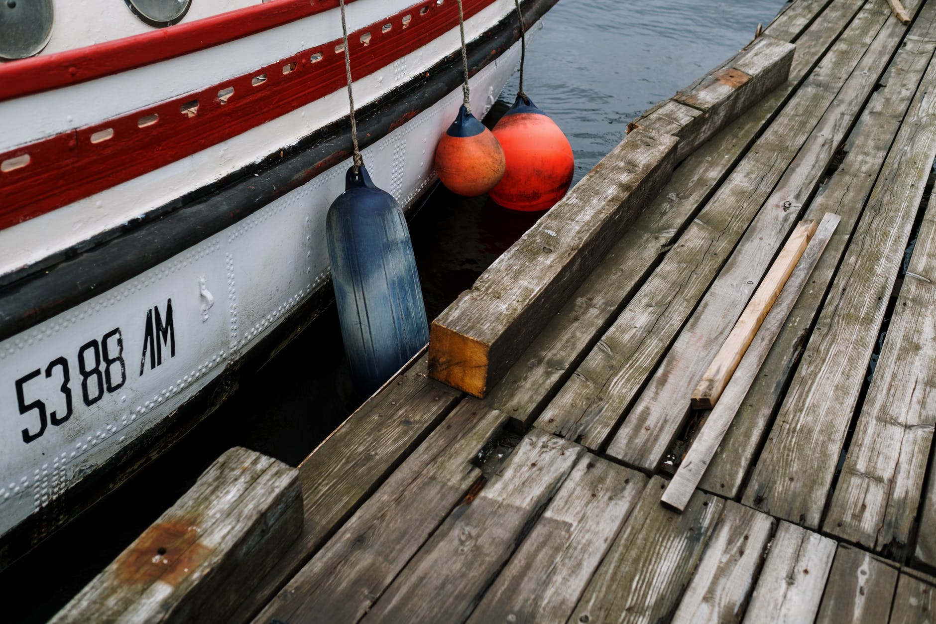 white and red boat on sea dock